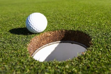 Golf ball on lip of the cup at Cedar Ridge Country Club